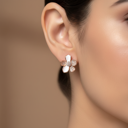 Extreme close-up of rose gold flower earring on model